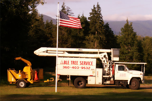 Able Tree Service lift truck and chipper ready for work